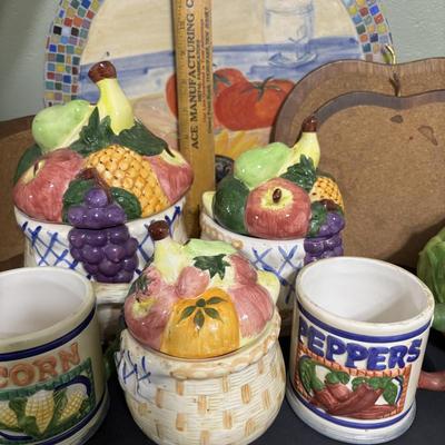 LOT 220: Fruit & Veggie Kitchen Collection: Home Interiors Vegetable Plaques, Apple Hot Plates Fruit Canisters, Holland Mold Ceramic...