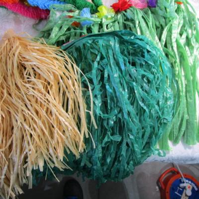 5 grass skirts (made of plastic), 22 plastic leis