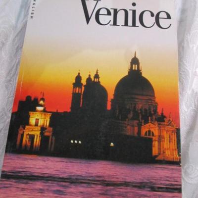 3 travel books, 1 travel magazine, 1 folder, 1 atlas