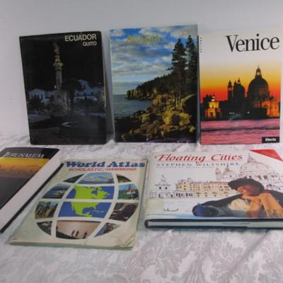 3 travel books, 1 travel magazine, 1 folder, 1 atlas
