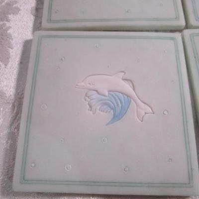 Vintage ceramic 4 coaster set with dolphins on waves holder