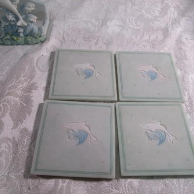 Vintage ceramic 4 coaster set with dolphins on waves holder