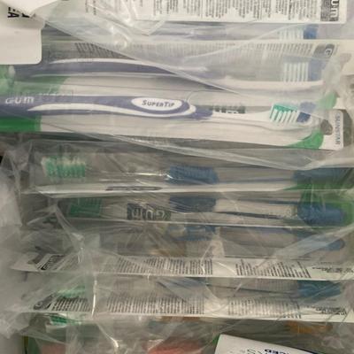 Tote with toothbrushes, pics and floss