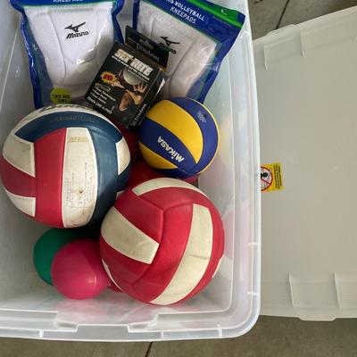 Volleyballs and knee pads in tote