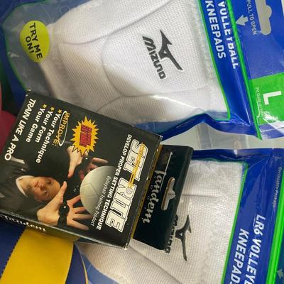 Volleyballs and knee pads in tote