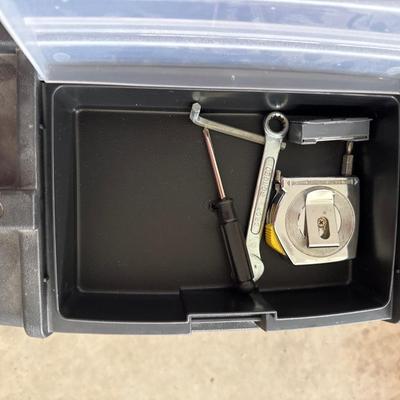 Black plastic toolbox with tools in it