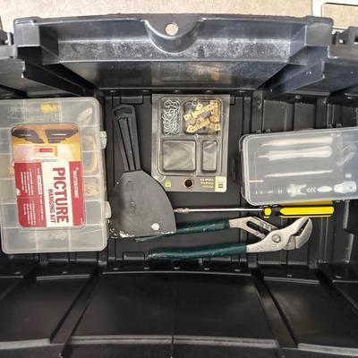 Black plastic toolbox with tools in it