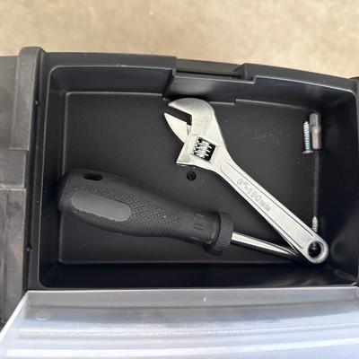Black plastic toolbox with tools in it