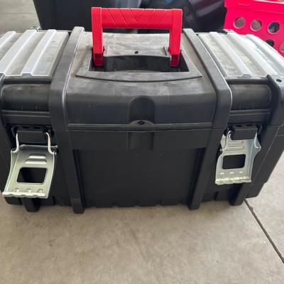 Black plastic toolbox with tools in it