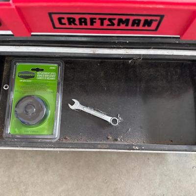 Black and red craftsman toolbox with tools inside