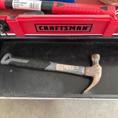Black and red craftsman toolbox with tools inside