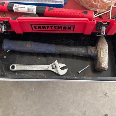 Black and red craftsman toolbox with tools inside