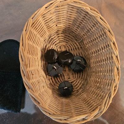 Buttons in a small basket and plates