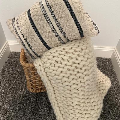 Basket with blanket and pillow decor