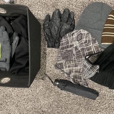 Small basket of gloves and hats with umbrella