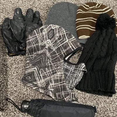 Small basket of gloves and hats with umbrella