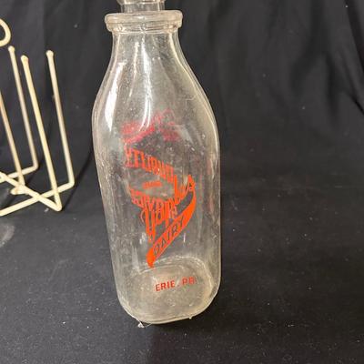 4 Vintage milk bottles with cage