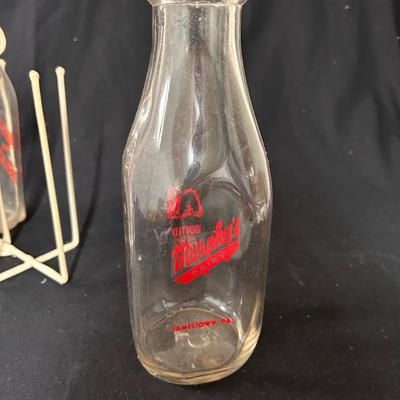 4 Vintage milk bottles with cage