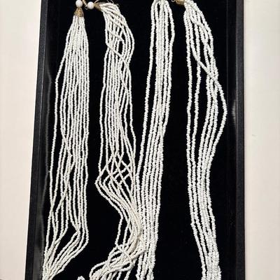 Two beaded white necklaces