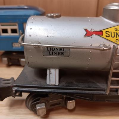 LIONEL BLUE COMET PASSENGER TRAIN, SUNOCO TANK CAR, A BOXCAR, RAILROAD LIGHT AND NO CROSSING