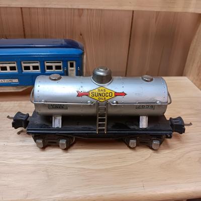 LIONEL BLUE COMET PASSENGER TRAIN, SUNOCO TANK CAR, A BOXCAR, RAILROAD LIGHT AND NO CROSSING