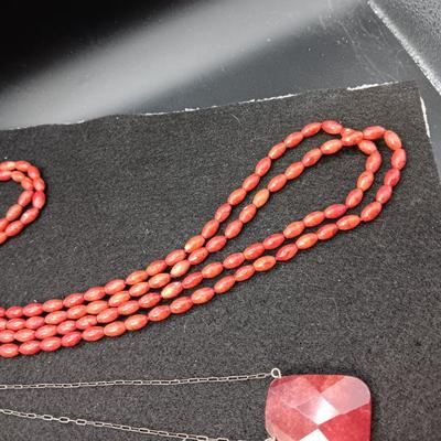 RED STONE ON STERLING CHAIN AND RED BEADED LONG NECKLACE