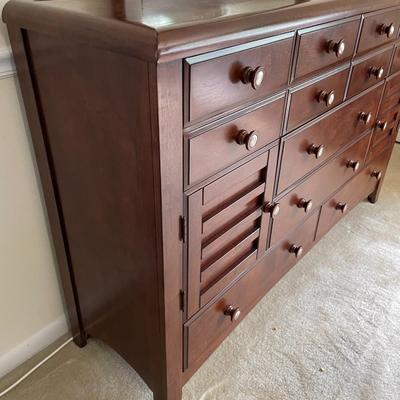 Sale Photo Thumbnail #134: Dark wood. In great Condition. 6 Drawers and 2 side openings. Mirror included. Matches LOT 23 and 25. Measures 64L x 18W x 41.5H. Mirror Measures 40L x 44H.
