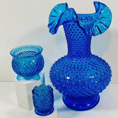 LOT 6: Collection of Blue Glass Vases Featuring Fenton Colonial Blue Hobnail Ruffle Top Vase and More