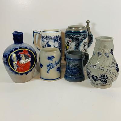 LOT 21: Assortment of Ceramic Mugs, Steins, and Bottles Featuring a Blue Delft Heineken Mug