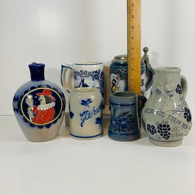 LOT 21: Assortment of Ceramic Mugs, Steins, and Bottles Featuring a Blue Delft Heineken Mug