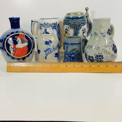 LOT 21: Assortment of Ceramic Mugs, Steins, and Bottles Featuring a Blue Delft Heineken Mug