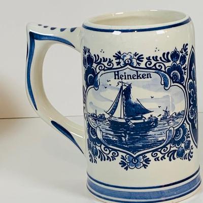 LOT 21: Assortment of Ceramic Mugs, Steins, and Bottles Featuring a Blue Delft Heineken Mug