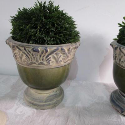 2 faux plants in decorative planters, 2 wood candlesticks, 1 decorative plate