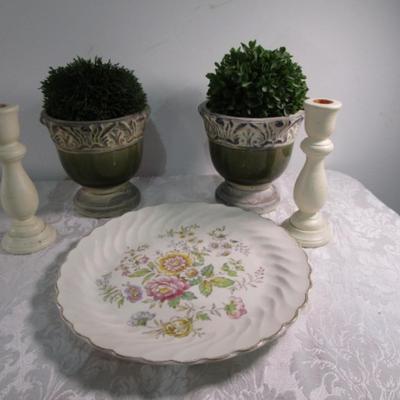 2 faux plants in decorative planters, 2 wood candlesticks, 1 decorative plate