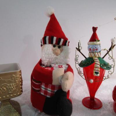 Christmas decorations and Santa holds 3 hand towels