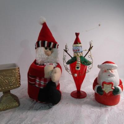 Christmas decorations and Santa holds 3 hand towels