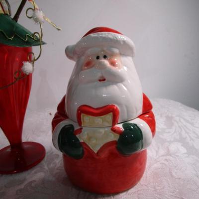Christmas decorations and Santa holds 3 hand towels