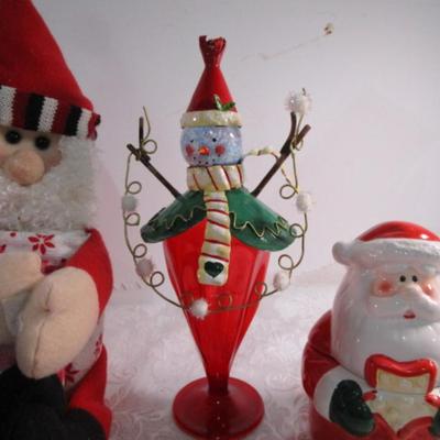Christmas decorations and Santa holds 3 hand towels