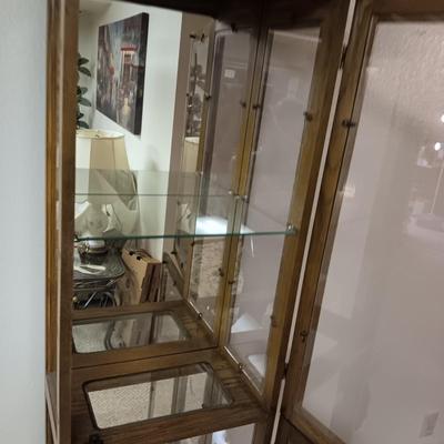 NARROW CURIO CABINET WITH A MIRRORED BACK