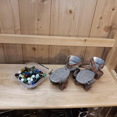 BOWL FULL OF MARBLES AND LEATHER STRAP ROLLER SKATES