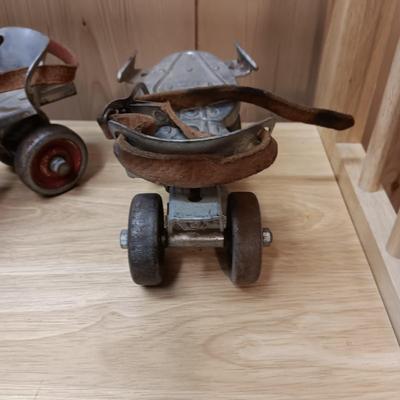 BOWL FULL OF MARBLES AND LEATHER STRAP ROLLER SKATES