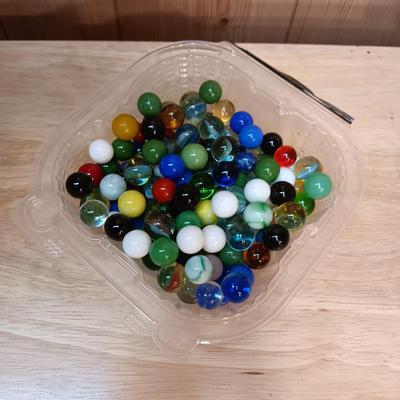 BOWL FULL OF MARBLES AND LEATHER STRAP ROLLER SKATES