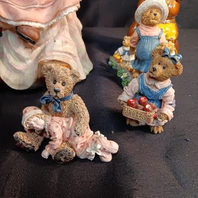 LARRGE GRANDMA IN A ROCKER AND VARIOUS FIGURINES SURROUNDING HER
