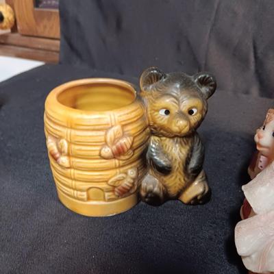 LARRGE GRANDMA IN A ROCKER AND VARIOUS FIGURINES SURROUNDING HER
