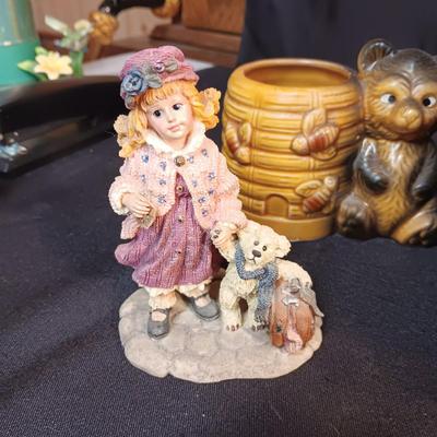 LARRGE GRANDMA IN A ROCKER AND VARIOUS FIGURINES SURROUNDING HER