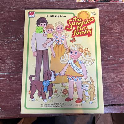 LOT 297: NIP 1998 Happy Holiday Barbie, 1985 Barbie Magazine & 1979 Sunshine Family Coloring Book