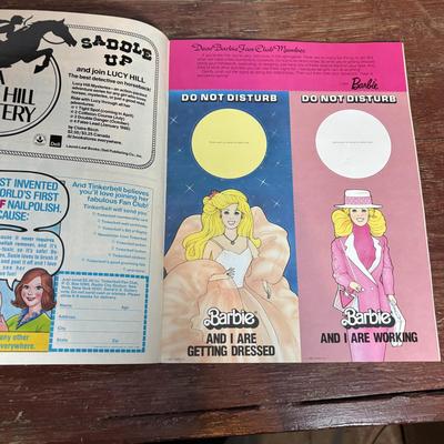 LOT 297: NIP 1998 Happy Holiday Barbie, 1985 Barbie Magazine & 1979 Sunshine Family Coloring Book