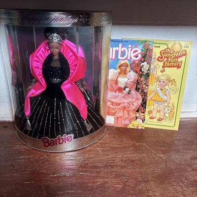 LOT 297: NIP 1998 Happy Holiday Barbie, 1985 Barbie Magazine & 1979 Sunshine Family Coloring Book