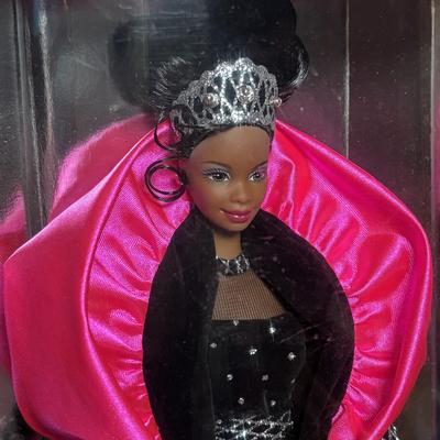 LOT 297: NIP 1998 Happy Holiday Barbie, 1985 Barbie Magazine & 1979 Sunshine Family Coloring Book