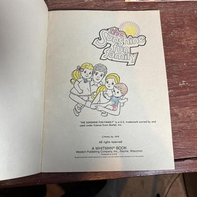 LOT 297: NIP 1998 Happy Holiday Barbie, 1985 Barbie Magazine & 1979 Sunshine Family Coloring Book